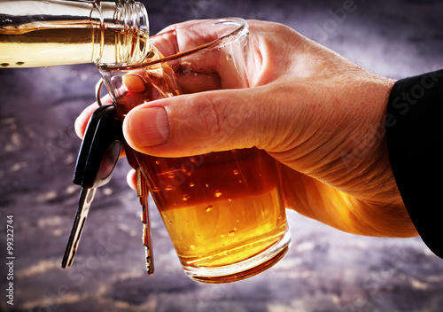 Fotografie, Obraz man holding car key and glass with alcohol