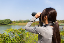 The Back View Of Asian Young Woman Using Binocular