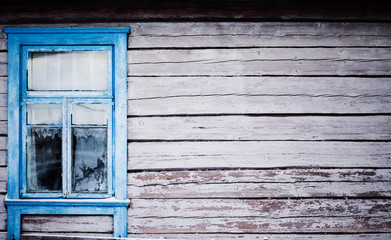 blue  window on house with peeling paint