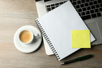 Poster - Empty yellow adhesive paper, notebook on laptop keyboard, pen and coffee cup on desk background