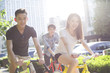 © Blue Jean Images - Happy young adults riding bicycles