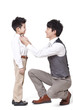 © Blue Jean Images - Smiling father fastening bow tie for son