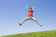 © Blue Jean Images - Cheerful young man jumping on grass