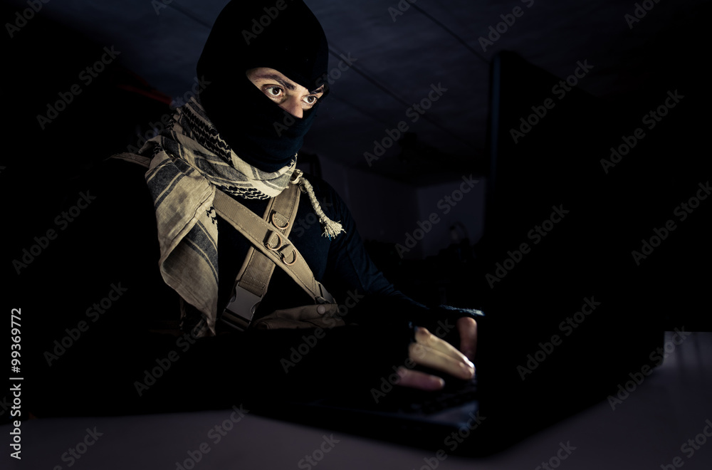 Computer hacker working on his laptop