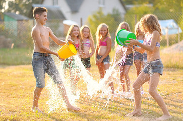 Wall Mural - Portrait of happy children on nature in summer