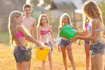 Wall Mural - Portrait of happy children on nature in summer