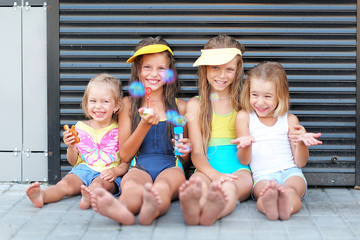 Wall Mural - Portrait of happy children on nature in summer