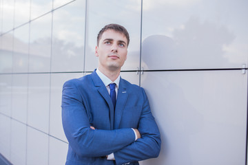 Portrait of a young businessman standing over blurred background 