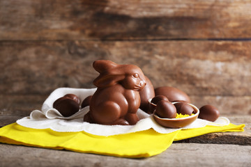 Sticker - Easter chocolate bunny and eggs on wooden background