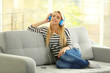 © Africa Studio - Young woman on a sofa listening to music