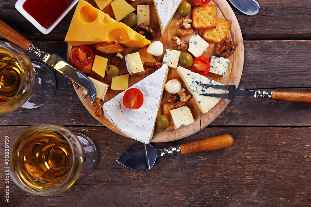 Cheese for tasting on wooden background, top view