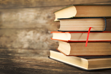 Sticker - Pile of books on wooden background