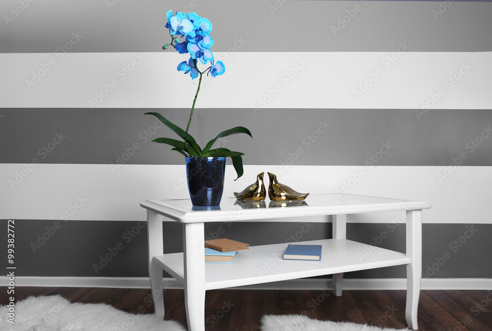 Beautiful blue orchid on the table in the room, close up