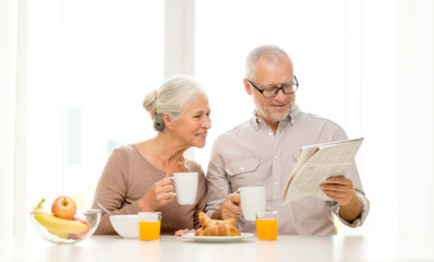 Canvas Print - happy senior couple having breakfast at home