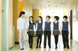 © Blue Jean Images - Teacher and students walking down hallway