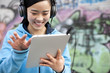 © Blue Jean Images - Woman listening to music with digital tablet
