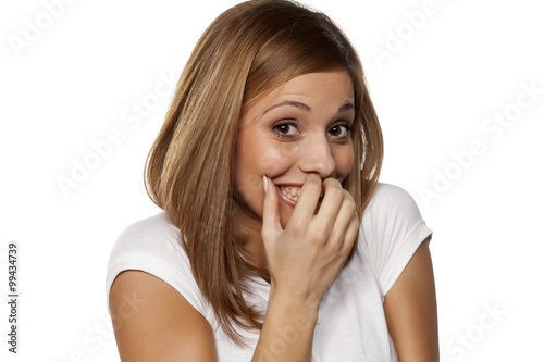 Cuadros en Lienzo smiling a shy young woman on a white background