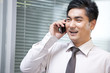 © Blue Jean Images - Confident Businessman Talking on Cell Phone