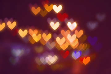 Bokeh hearts background, natural lens bokeh of night city lights.