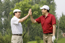Two Golfers Celebrate A Great Shot