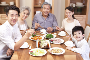 Wall Mural - Happy family enjoying meal time