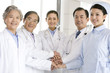 © Blue Jean Images - Doctors and Nurse Hands in a Huddle