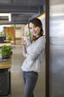 © Blue Jean Images - Young woman drinking coffee in office