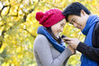 © Blue Jean Images - Young Couple Text Messaging Together