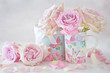 Beautiful fresh pink roses in a beautiful box on a light background .