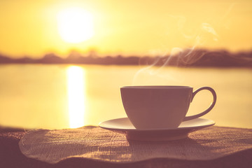 Silhouettes of sunrise morning coffee with a note and a pen