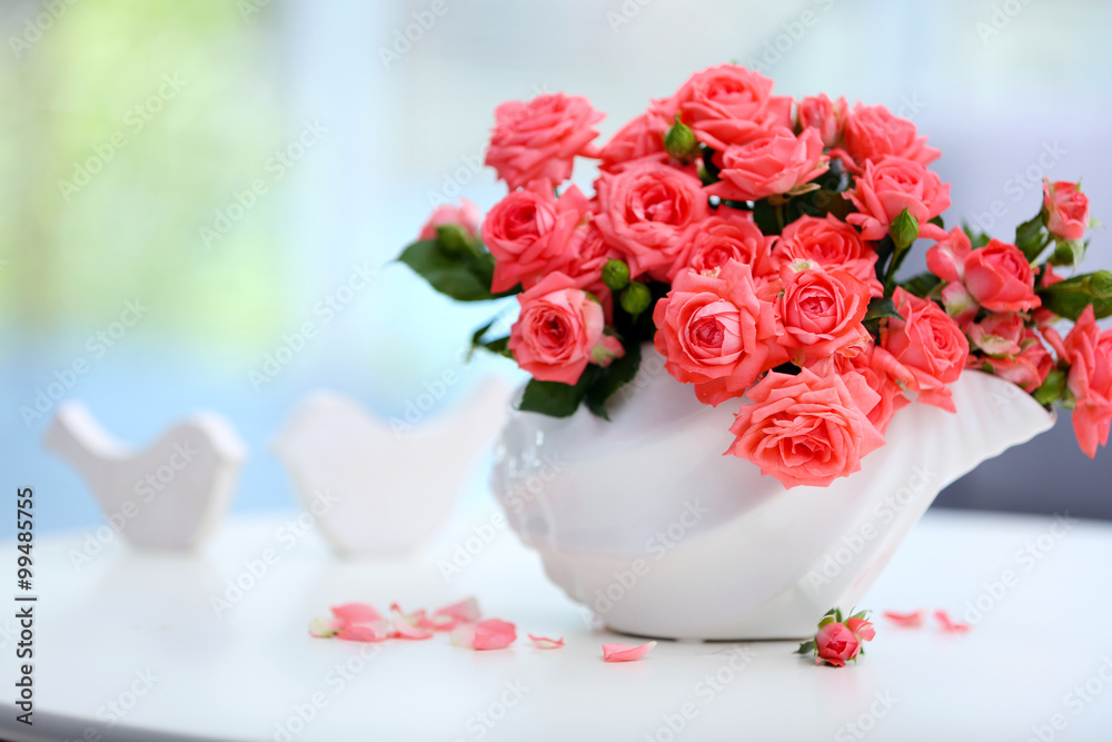 Beautiful rose in vase on table in room