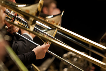 Wall Mural - Hands of man playing the trombone in the orchestra