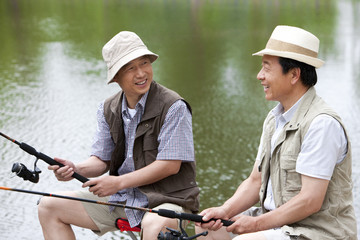 Senior friends fishing together