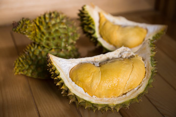 Close up of peeled ripe durian on wooden background