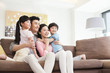 © Blue Jean Images - Happy family resting in sofa