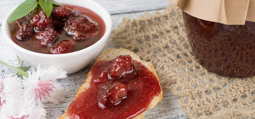 Poster - Canned strawberry confiture and jam sandwich on the wooden board