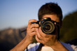 © Blue Jean Images - Young man taking a photo at the Great Wall of China