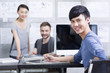 © Blue Jean Images - Young man with colleagues in office