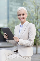 Sticker - smiling businesswoman with tablet pc outdoors