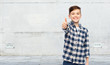 © Syda Productions - smiling boy in checkered shirt showing thumbs up