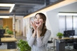 © Blue Jean Images - Young woman shouting in office