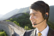Businessman With Headsets On The Great Wall
