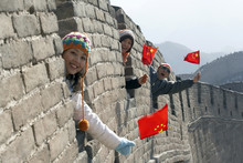 Young People Holding Flags On The Great Wall Of China