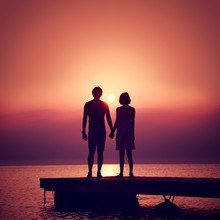 Romantic Couple Enjoying Sunset At Sea. 