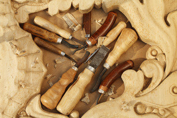 Wall Mural - carving tool closeup on wooden background