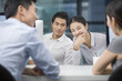 © Blue Jean Images - Young business people talking in office
