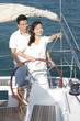 © Blue Jean Images - Young couple sailing