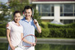 Portrait of young couple with tennis rackets
