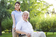 © Blue Jean Images - Wheelchair bound man with nursing assistant