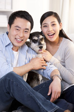 Young Couple With Pet Schnauzer